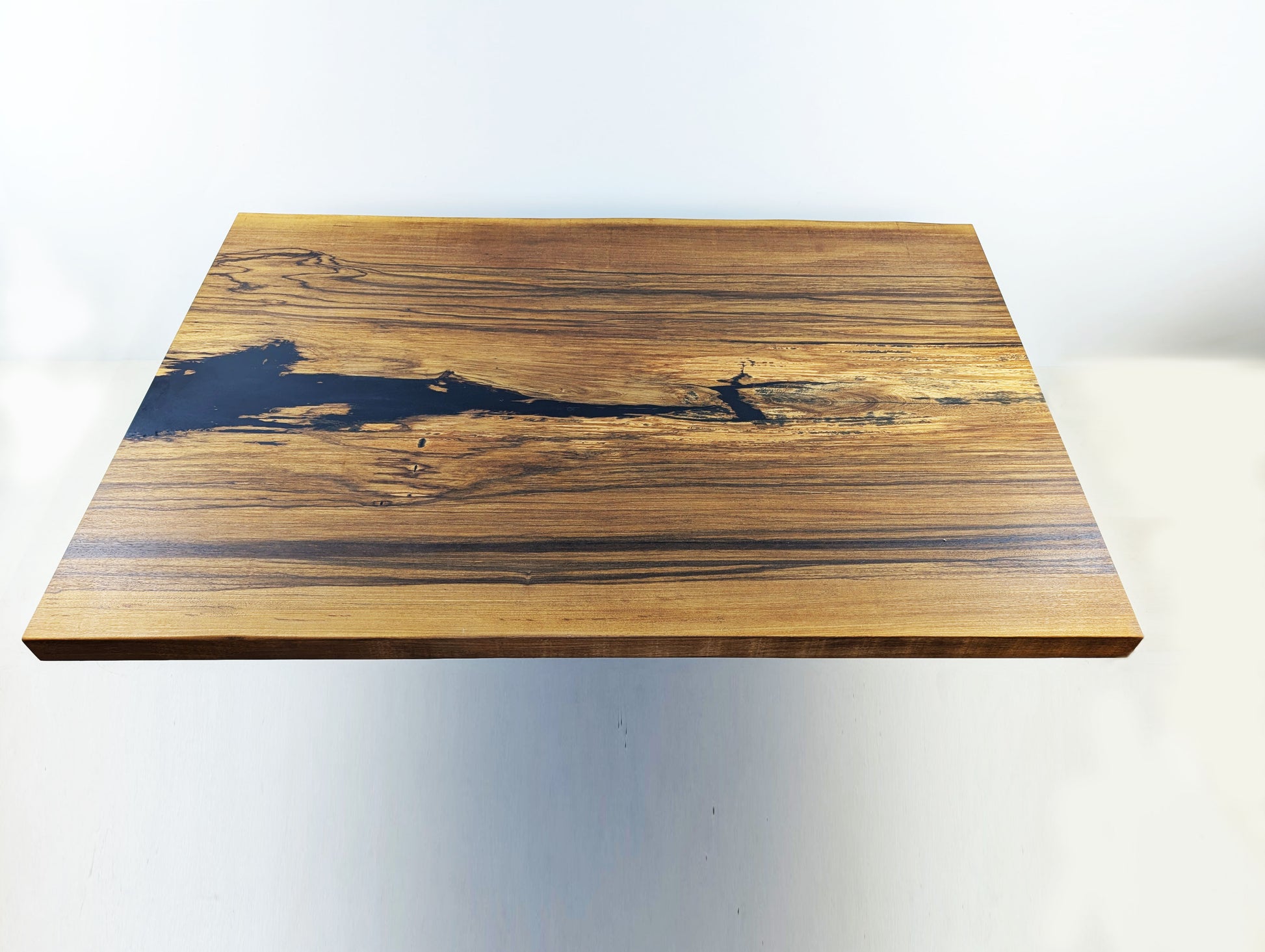 White Ebony Tischplatte von oben – grafische Struktur, kontrastreiche Maserung und handwerkliche Präzision by Steigerwood
